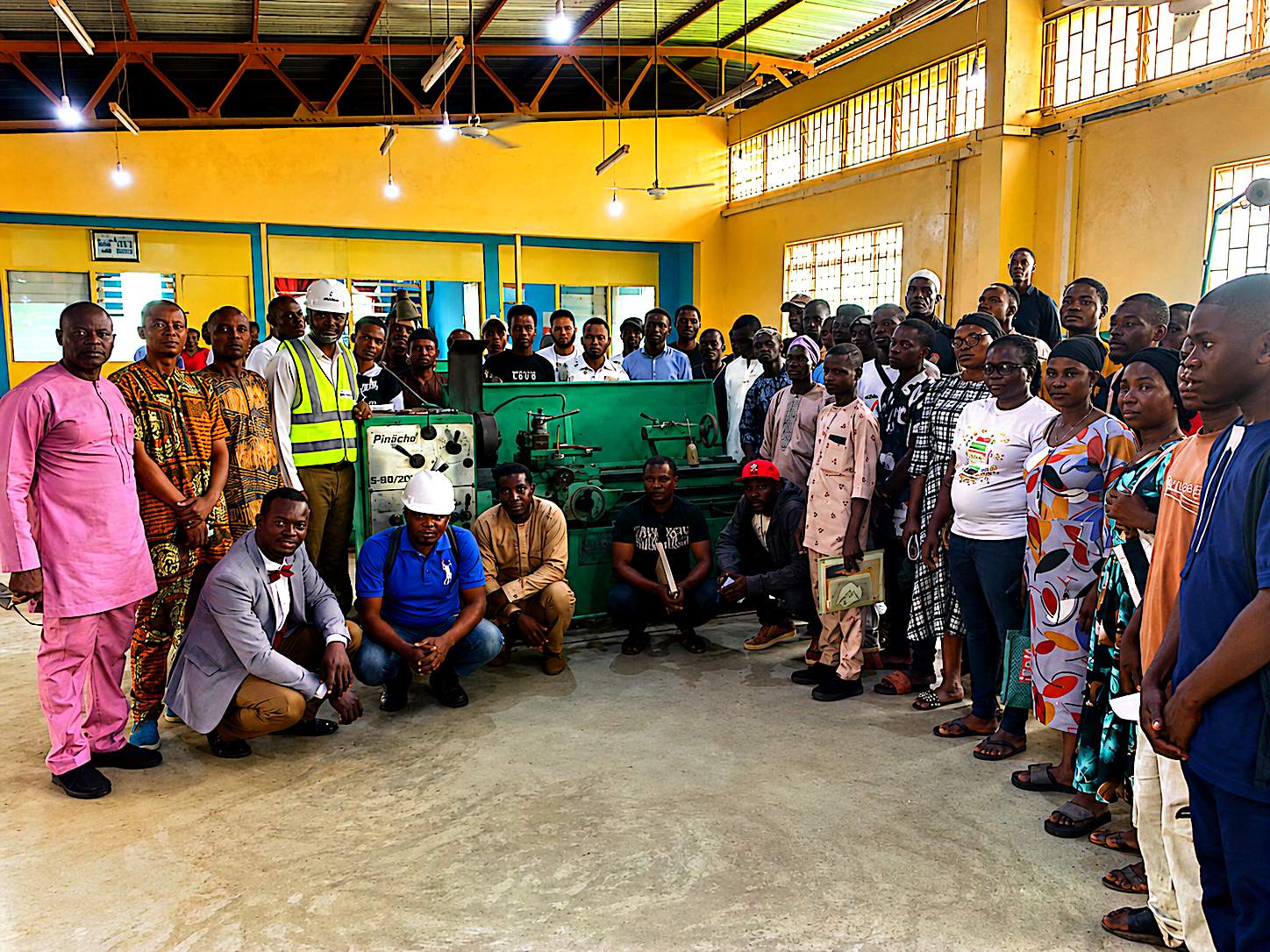 Group photo with the lathe machine after workshop induction