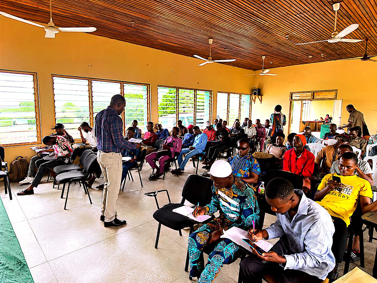 Trainees completing written coursework during theory sessions