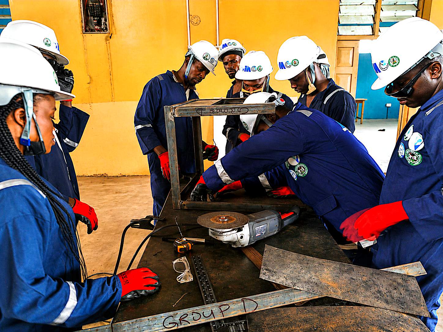 Team fabricating a welded steel frame — Group D bench work