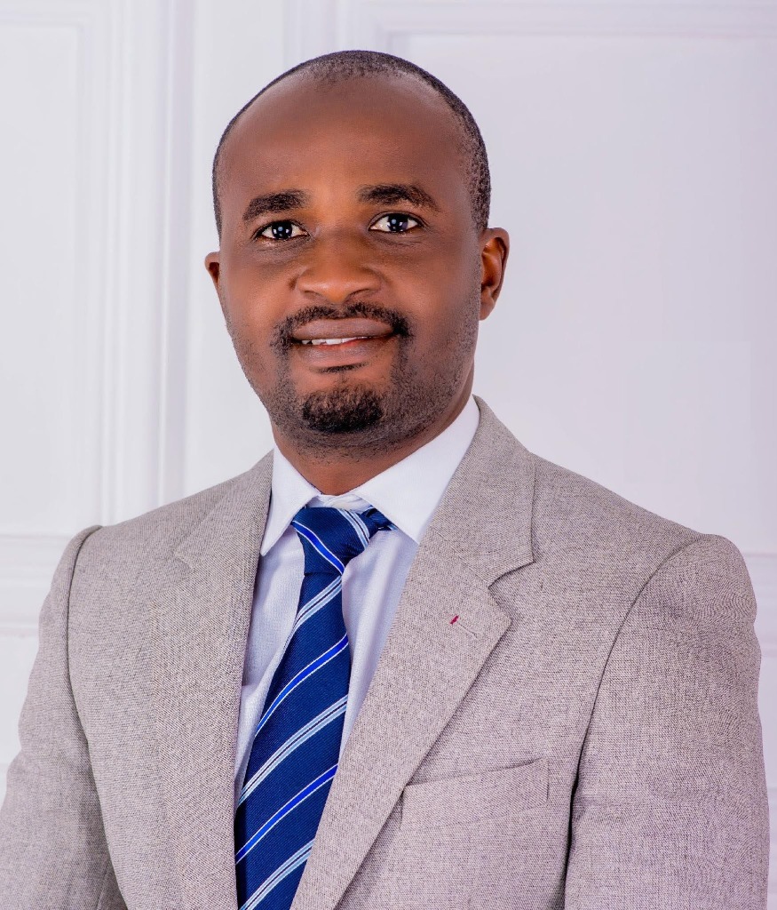 Engr. Bolaji Abiodun Jegede wearing a grey suit and a blue-striped tie